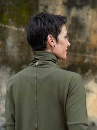 caraucci forest green bamboo fleece jacket, shown buttoned into a high cowl neck with thumbholes and pockets #color_forest