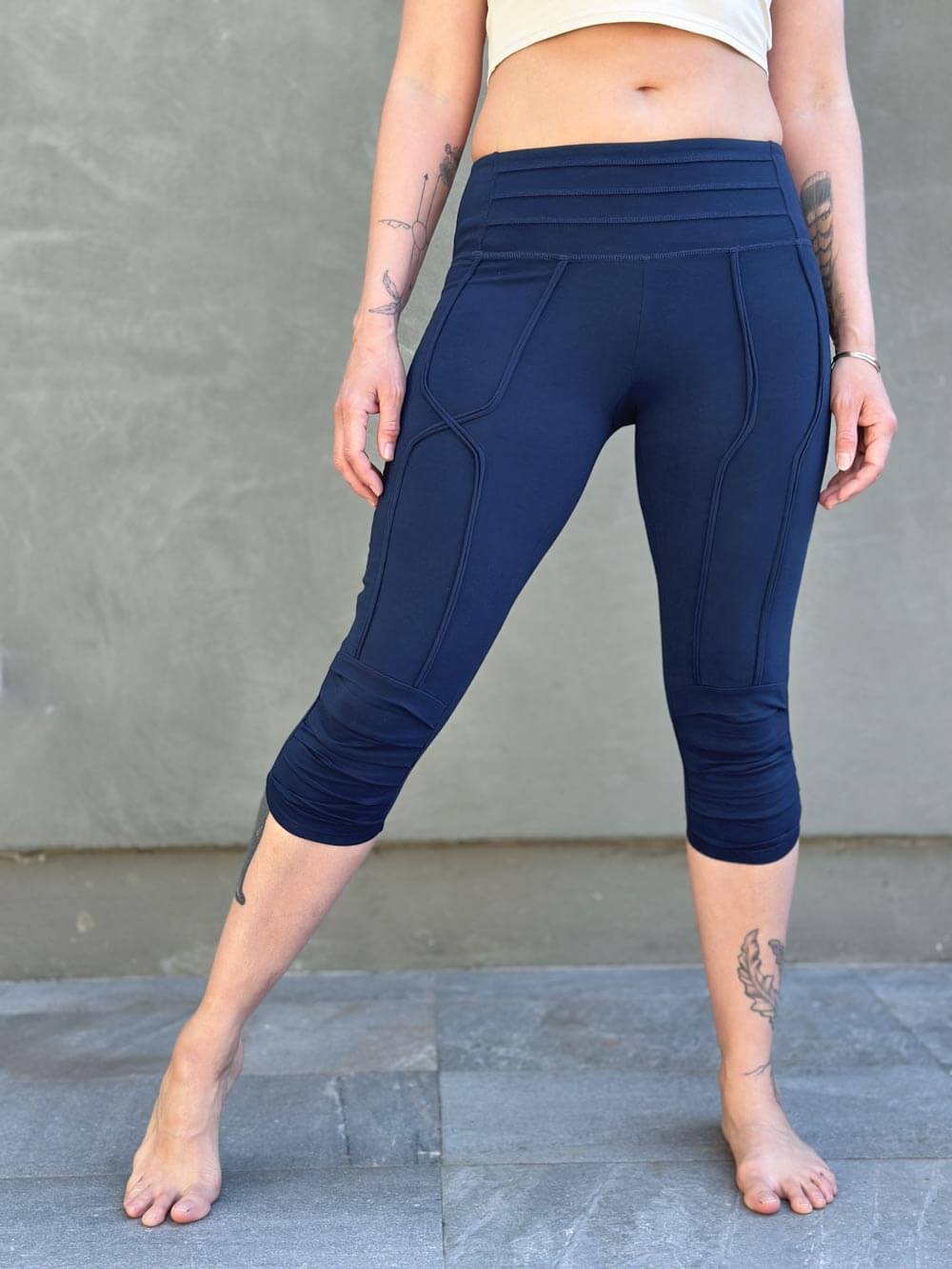 women's cotton lycra stretchy navy blue capri leggings with ruched knees and raised detail stitching #color_navy