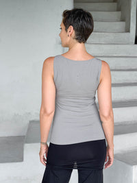 caraucci-woman-wearing-light-gray-boat-neck-tank-top-in-rayon-jersey-layered-over-black-skirt-pants #color_stone