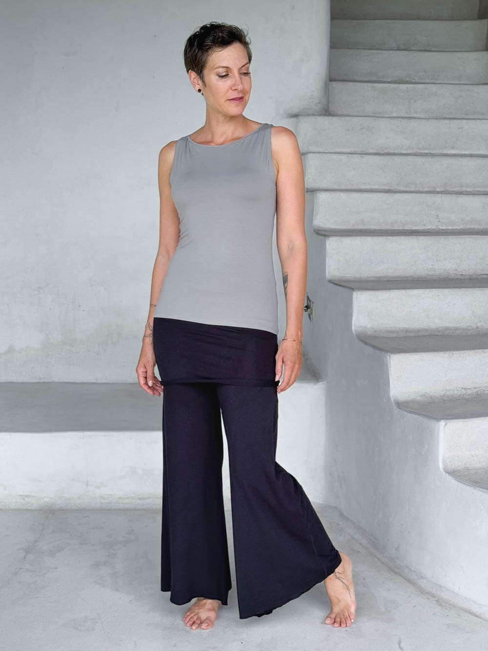caraucci-woman-wearing-light-gray-boat-neck-tank-top-in-rayon-jersey-layered-over-black-skirt-pants #color_stone