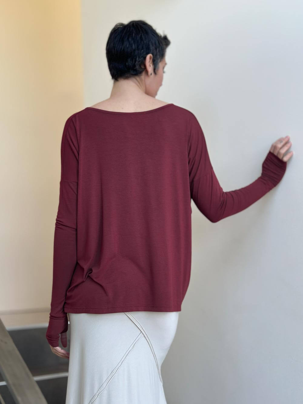 women's plant-based maroon relaxed fit jersey long sleeve top shown as a shrug #color_wine