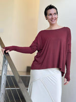 women's plant-based maroon relaxed fit jersey long sleeve top shown as a shrug #color_wine