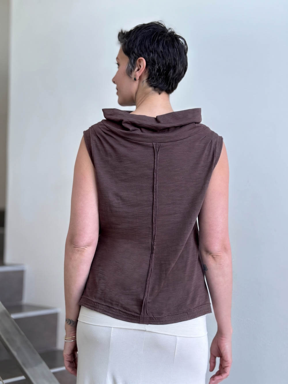 Back view of CARAUCCI Cotton Cowl Neck Tank in cocoa brown with draped neckline, center seam detail and cream skirt. #color_cocoa
