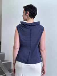 Back view of CARAUCCI Cotton Cowl Neck Tank in denim navy blue with draped neckline, center seam detail and cream skirt. #color_midnight