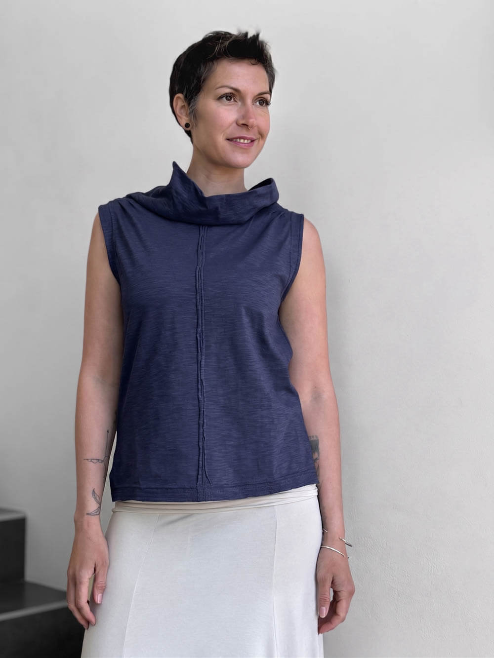 front view of CARAUCCI Cotton Cowl Neck Tank in denim navy blue with draped neckline, center seam detail and cream skirt. #color_midnight
