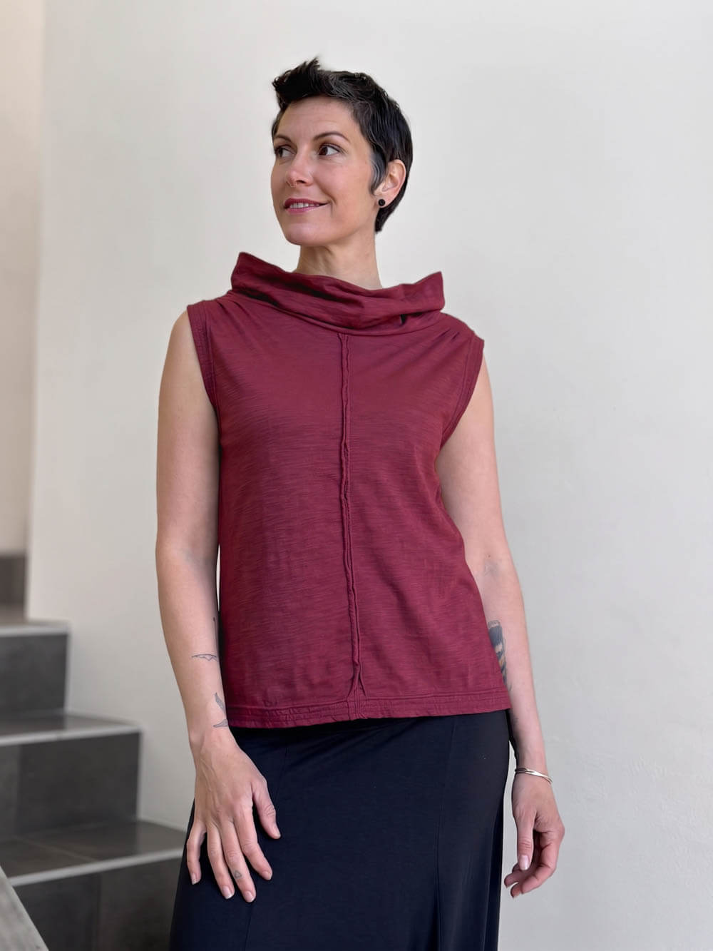 Front view of CARAUCCI Cotton Cowl Neck Tank in crimson maroon with draped neckline, center seam detail and black skirt. #color_crimson