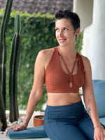 caraucci stretchy full coverage burnt orange yoga bra top with criss cross back straps #color_copper