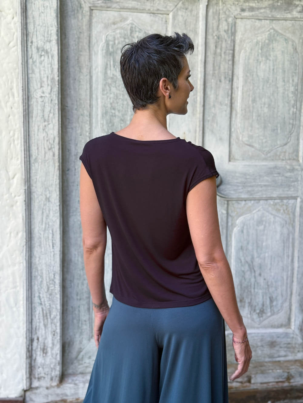 CARAUCCI Erna top in black lightweight rayon jersey with cap sleeves and draped neckline #color_black