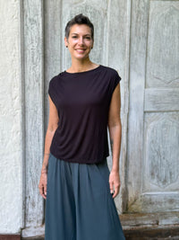 CARAUCCI Erna top in black lightweight rayon jersey with cap sleeves and draped neckline #color_black