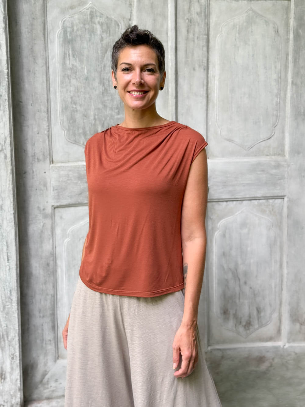 CARAUCCI Erna top in soft orange lightweight rayon jersey with cap sleeves and draped neckline #color_copper