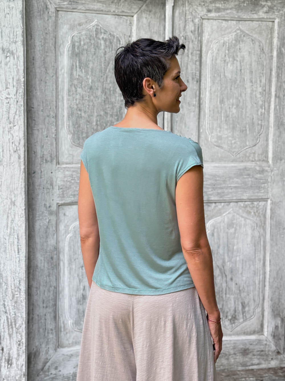 CARAUCCI Erna top in soft sage green lightweight rayon jersey with cap sleeves and draped neckline #color_moss