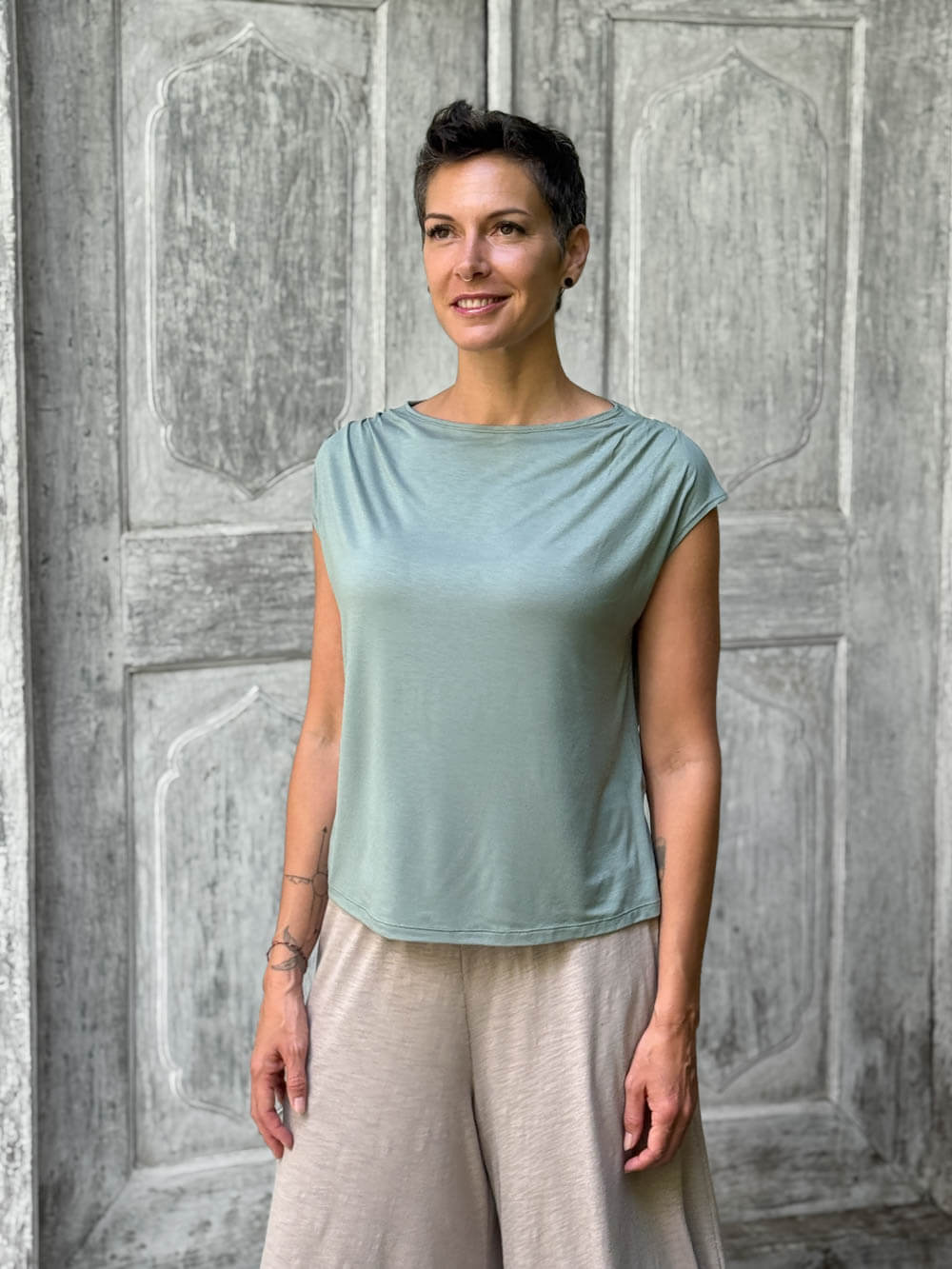 CARAUCCI Erna top in soft sage green lightweight rayon jersey with cap sleeves and draped neckline #color_moss