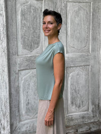 CARAUCCI Erna top in soft sage green lightweight rayon jersey with cap sleeves and draped neckline #color_moss