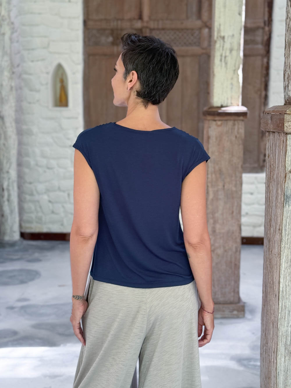 CARAUCCI Erna top in navy blue lightweight rayon jersey with cap sleeves and draped neckline #color_navy