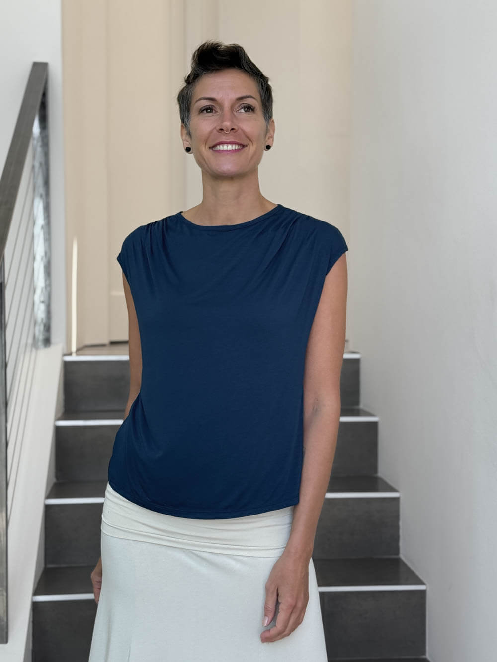 CARAUCCI Erna top in navy blue lightweight rayon jersey with cap sleeves and draped neckline #color_navy
