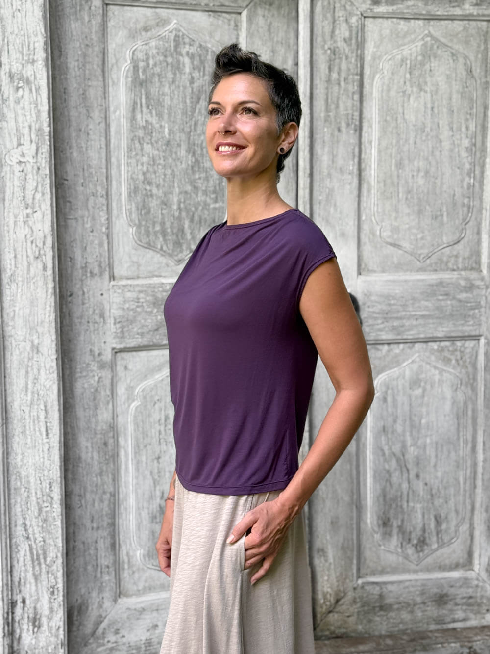 CARAUCCI Erna top in purple lightweight rayon jersey with cap sleeves and draped neckline #color_plum