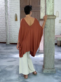 caraucci lightweight jersey draped soft orange kaftan tunic with open shoulders #color_copper