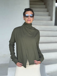 caraucci forest green bamboo fleece jacket, shown buttoned into a high cowl neck with thumbholes and pockets #color_forest
