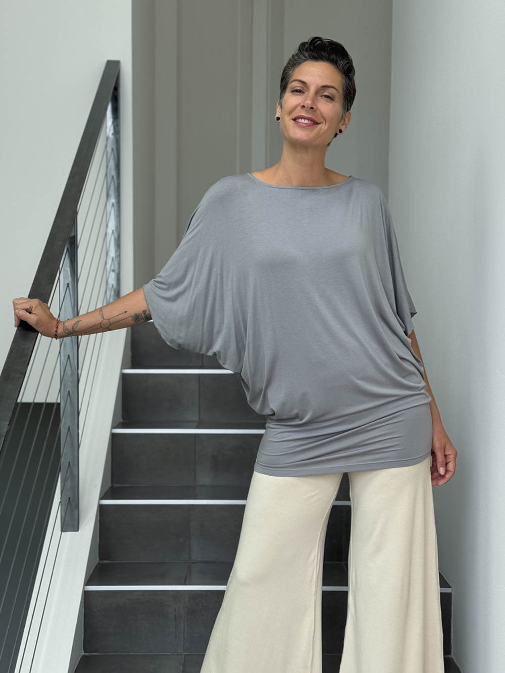 caraucci gray dolman sleeve draped tunic worn as a tunic with cream pants #color_stone