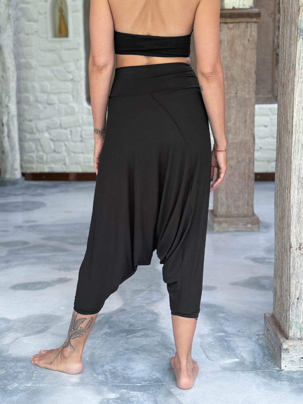 caraucci draped black harem style movement pants with soft waistband and cropped silhouette #color_black