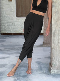 caraucci draped black harem style movement pants with soft waistband and cropped silhouette #color_black