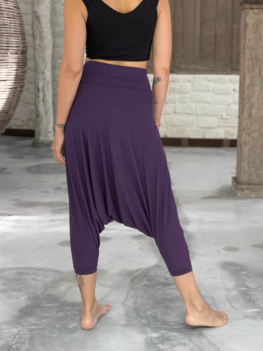 caraucci draped purple harem style movement pants with soft waistband and cropped silhouette #color_plum