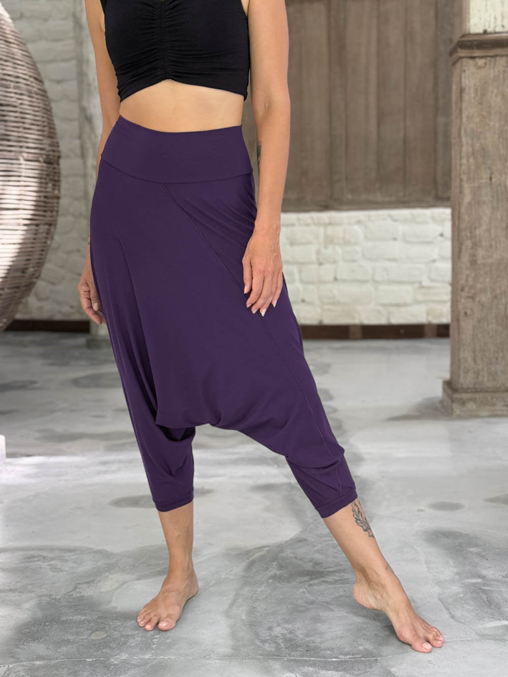 caraucci draped purple harem style movement pants with soft waistband and cropped silhouette #color_plum