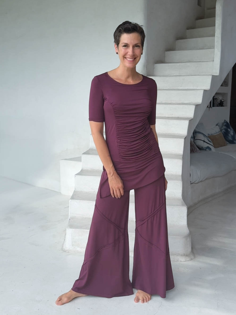 women's skirt-over purple wide leg pants with raised diagonal stitching shown with purple short sleeve ruched top #color_jam