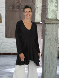 caraucci peplum tunic in black lightweight rayon jersey with v neckline and asymmetrical hem #color_black
