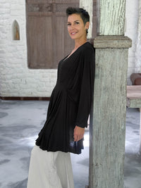caraucci peplum tunic in black lightweight rayon jersey with v neckline and asymmetrical hem #color_black