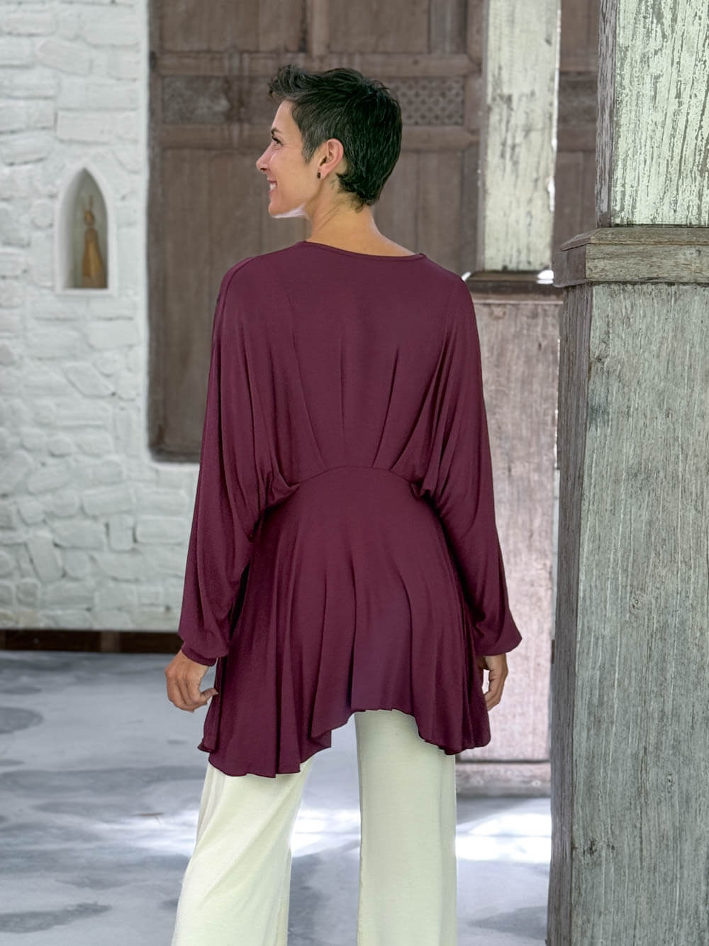 caraucci peplum tunic in purple lightweight rayon jersey with v neckline and asymmetrical hem #color_jam