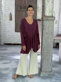 caraucci peplum tunic in purple lightweight rayon jersey with v neckline and asymmetrical hem #color_jam