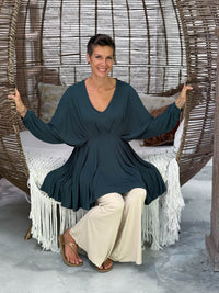 caraucci peplum tunic in teal blue lightweight rayon jersey with v neckline and asymmetrical hem #color_teal