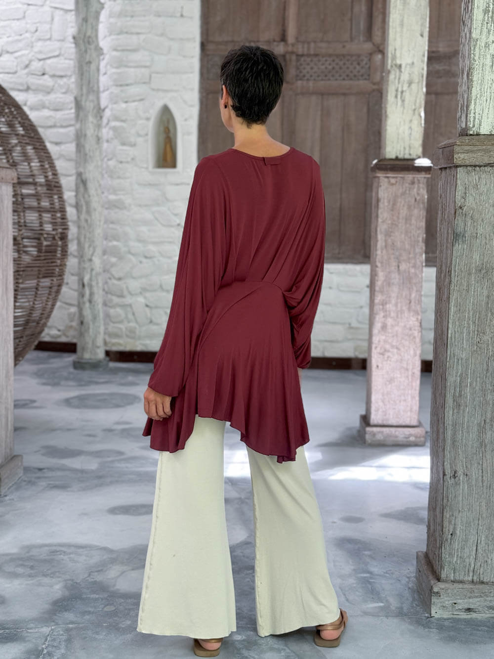 caraucci peplum tunic in maroon lightweight rayon jersey with v neckline and asymmetrical hem #color_wine