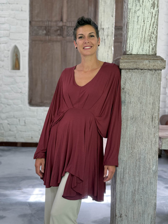 caraucci peplum tunic in maroon lightweight rayon jersey with v neckline and asymmetrical hem #color_wine