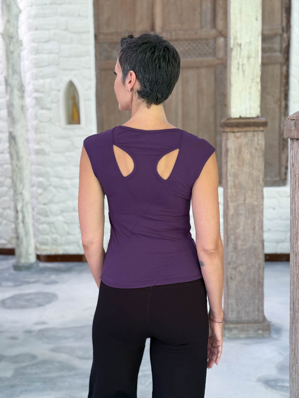 Back view of the CARAUCCI Racerback Top in purple featuring a bra-friendly racerback design #color_plum