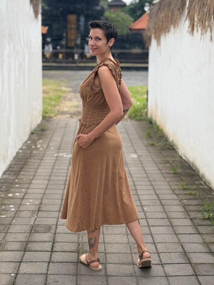 caraucci camel midi-length dress with smocked waist and sleeveless ruffled neckline and pockets #color_camel