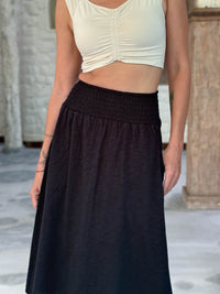 caraucci siena midi skirt in black cotton smocked waist midi skirt with pockets #color_black
