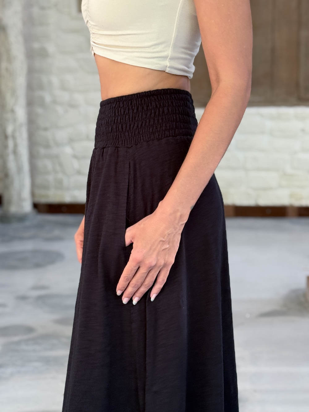 caraucci siena midi skirt in black cotton smocked waist midi skirt with pockets #color_black