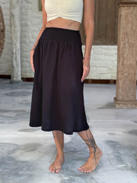 caraucci siena midi skirt in black cotton smocked waist midi skirt with pockets #color_black