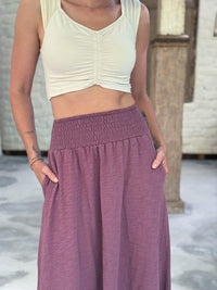 caraucci siena midi skirt in muted mauve cotton smocked waist midi skirt with pockets #color_mangosteen