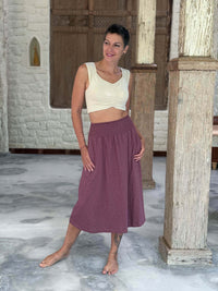 caraucci siena midi skirt in muted mauve cotton smocked waist midi skirt with pockets #color_mangosteen