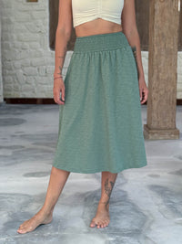 caraucci siena midi skirt in soft sage green cotton smocked waist midi skirt with pockets #color_matcha