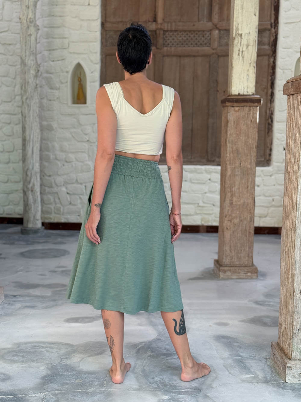 caraucci siena midi skirt in soft sage green cotton smocked waist midi skirt with pockets #color_matcha