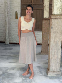caraucci siena midi skirt in soft stone neutral cotton smocked waist midi skirt with pockets and sweetheart cropped top in cream #color_sahara