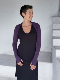 caraucci-woman-wearing-purple-sleeve-shrug-layered-over-cream-dress-with-thumbhole-detail #color_plum