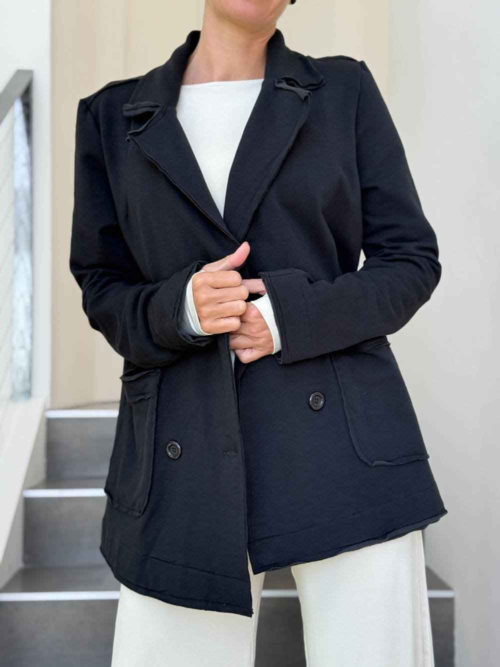 CARAUCCI Urban Lounge unstructured double-breasted black Bamboo Fleece jacket shown with cream flare pants #color_black