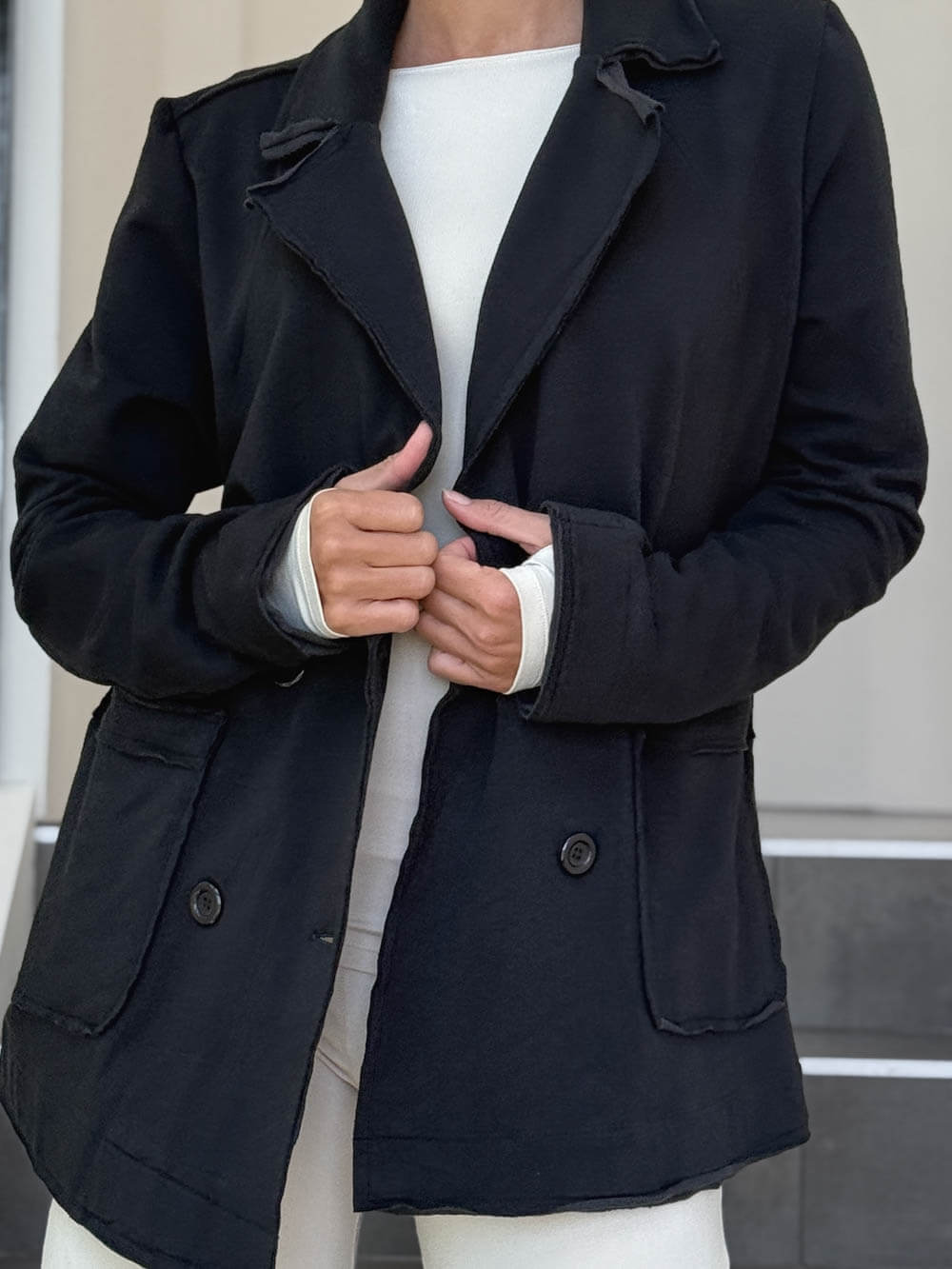 CARAUCCI Urban Lounge unstructured double-breasted black Bamboo Fleece jacket shown with cream flare pants #color_black