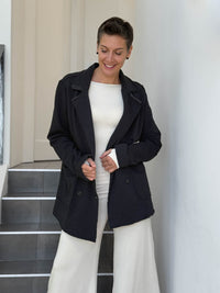 CARAUCCI Urban Lounge unstructured double-breasted black Bamboo Fleece jacket shown with cream flare pants #color_black