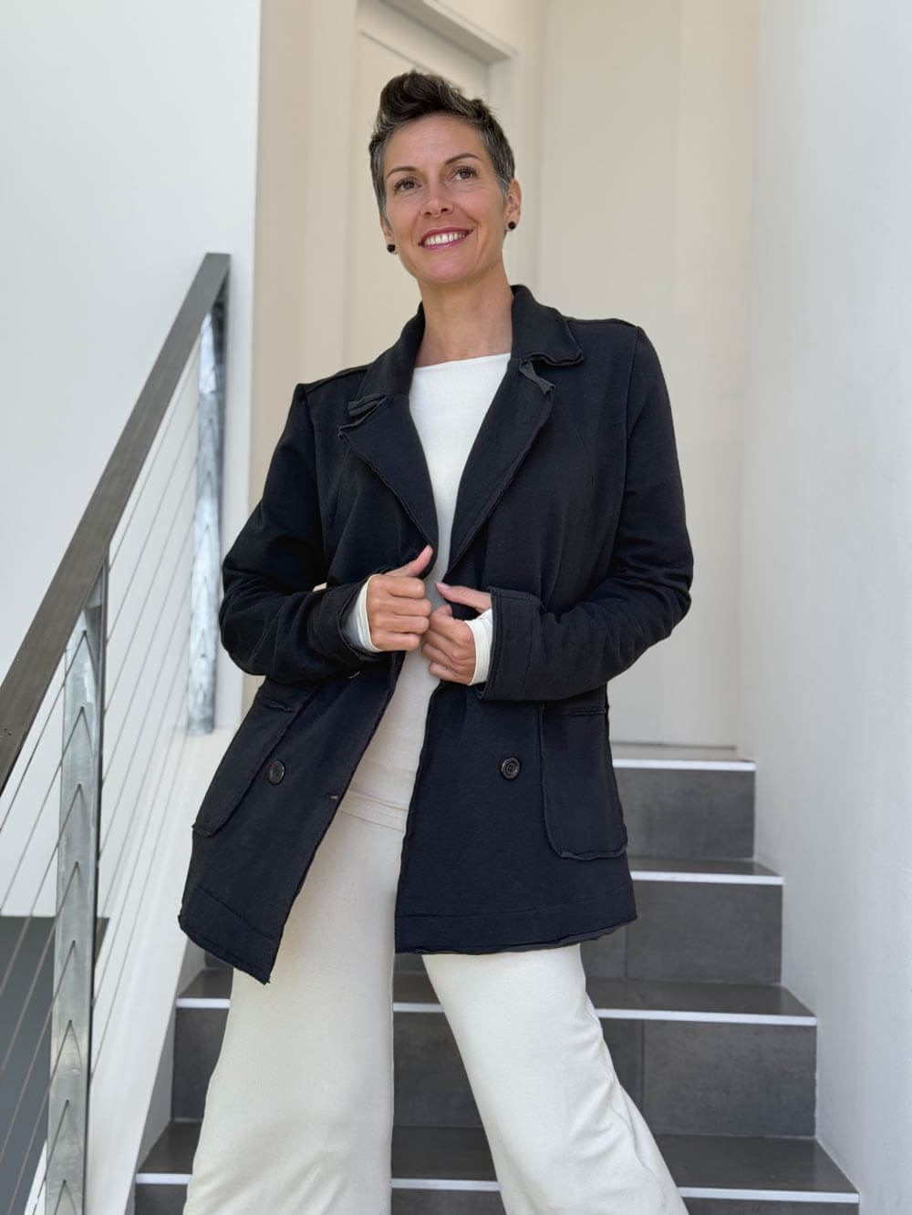 CARAUCCI Urban Lounge unstructured double-breasted black Bamboo Fleece jacket shown with cream flare pants #color_black